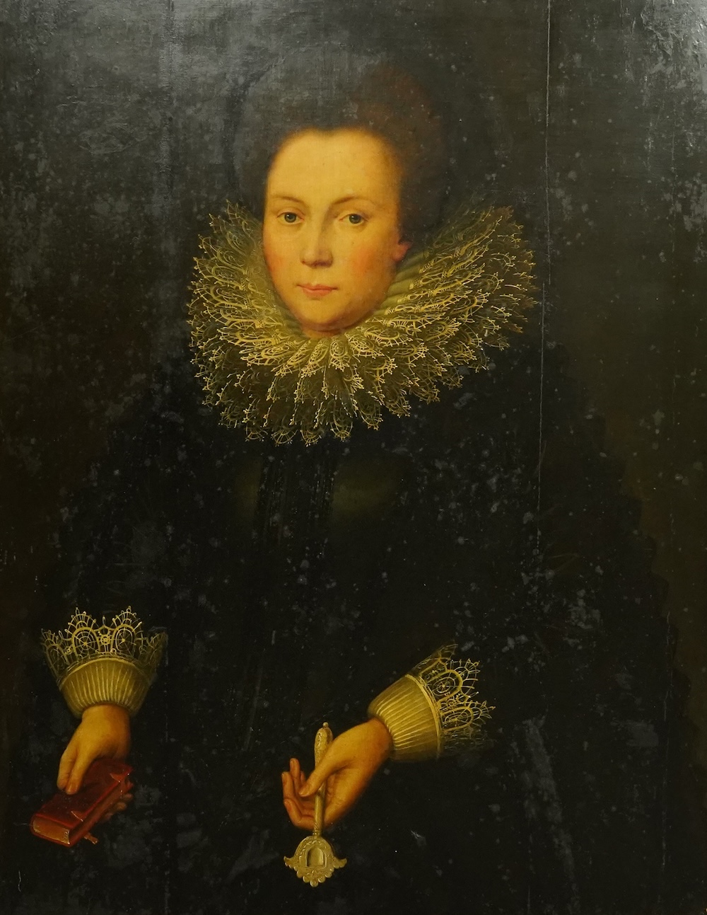 Circle of Cornelis Van der Voort (Dutch, 1576-1624), Half length portrait of a lady wearing a black dress and elaborate lace collar, holding a key and a missal, oil on panel, 89 x 70cm